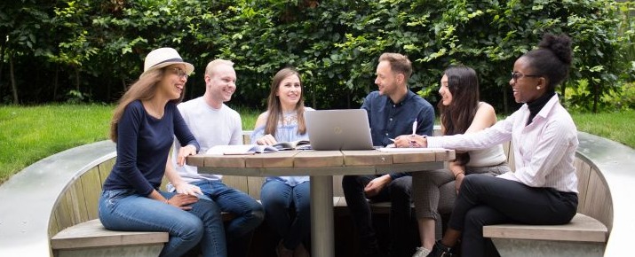 Students studying and socialising outdoors in Glasgow Caledonian University courtyard gardens